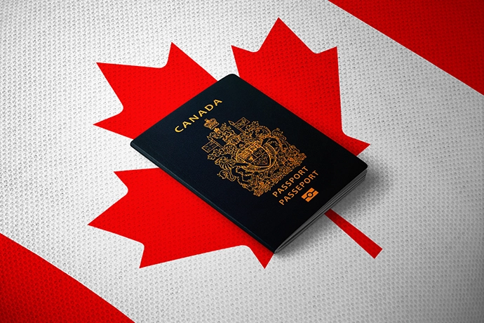 Picture of the Canadian flag and the Canadian passport on top of it